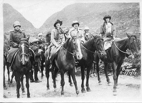 Bessie on horseback in the mountains with a group of others