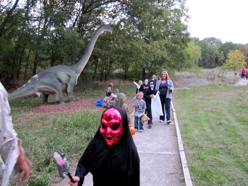 trick-or-treaters on the dinosaur trail at Halloween at the heard