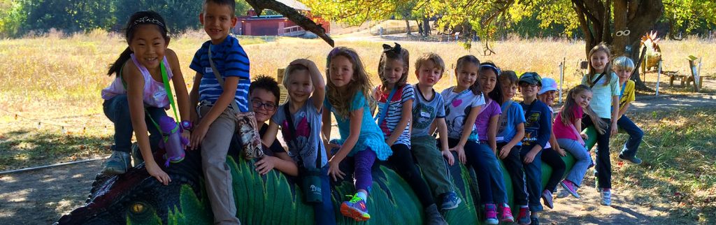 a group of students sitting on a dino