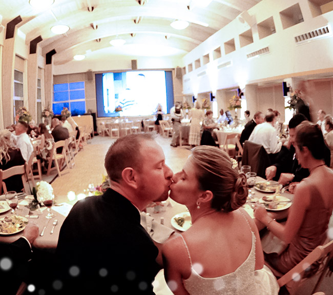 wedding celebration in the science resource center, bride and groom kissing